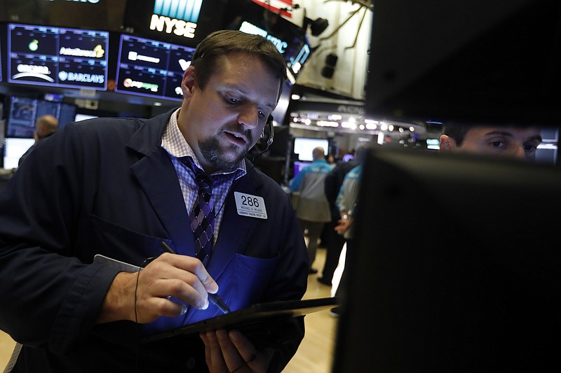 Trader Michale Milano, left, works on the floor of the New York Stock Exchange, Thursday, Nov. 14, 2019. Stocks are opening slightly lower on Wall Street led by a decline in technology companies. (AP Photo/Richard Drew)