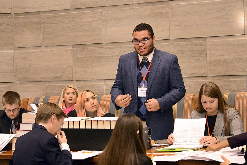 Komlavi Adissem practices his presentation for mock Bill 112 to ratify the equal rights amendment Thursday during the the first day of the YMCA Missouri Youth and Government Lewis State Convention at the Capitol. 