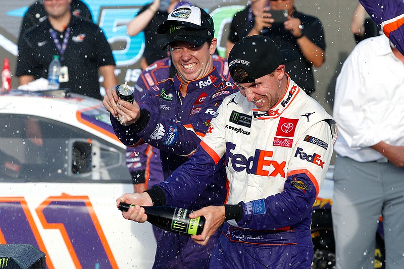 Denny Hamlin celebrates in victory lane after winning last Sunday's NASCAR Cup Series race at ISM Raceway in Avondale, Ariz. Hamlin, Kyle Busch, Martin Truex Jr. and Kevin Harvick will race for the championship Sunday.