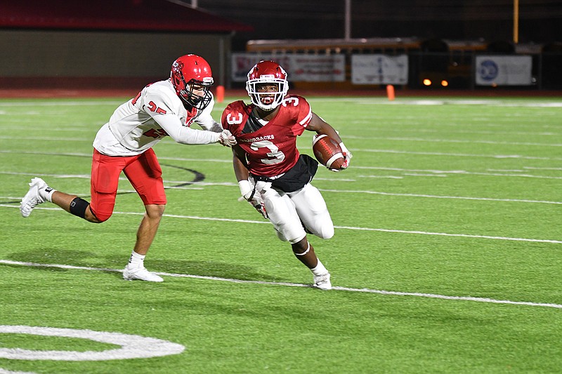 Arkansas High running back Torie Blair (3) tries to escape the grasp of a Maumelle defender during first half action Friday at Razorback Stadium in Texarkana, Ark. (Photo by Kevin Sutton)

