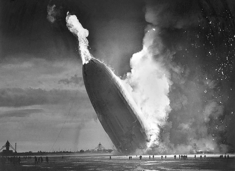 FILE - In this May 6, 1937 file photo, the German dirigible Hindenburg crashes to earth in flames after exploding at the U.S. Naval Station in Lakehurst, N.J. Werner Gustav Doehner, the last survivor of the disaster, died Nov. 8, 2019 at age 90 in Laconia, N.H. Doehner was 8-years old when he boarded the zeppelin in Germany with his parents and older siblings to return from a vacation. (AP Photo/Murray Becker, File)