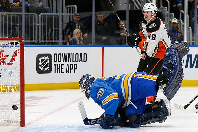 Max Jones of the Ducks watches as the puck gets past Blues goaltender Jordan Binnington for a goal during the first period of Saturday's game in St. Louis.