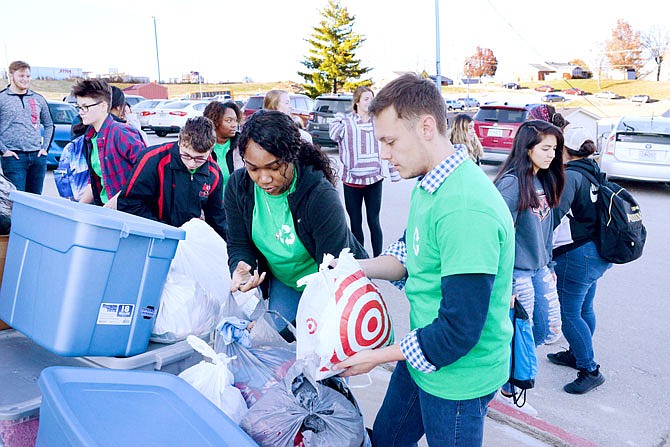 Students place bags of clothing in a pile Friday for the Green Team Clothing Drive at Jefferson City High School. The used clothing was collected from other students and was donated to The Salvation Army to decrease the amount of clothes that go to landfills.