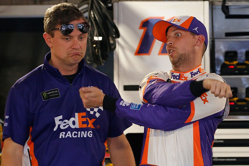 Denny Hamlin (right) talks to his crew chief, Chris Gabehart, last month after qualifying for the NASCAR Cup Series race at Martinsville Speedway in Martinsville, Va.