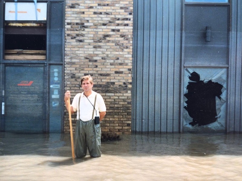 In this 1993 photo, Terry Rackers stands in floodwaters outside Jefferson City Flying Service.