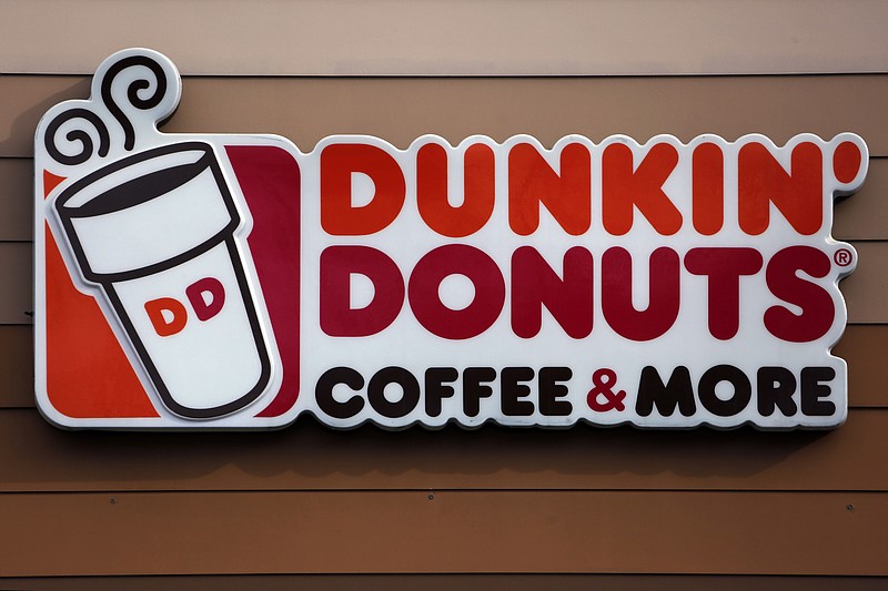 FILE- This Jan. 22, 2018 file photo shows the Dunkin' Donuts logo on a shop in Mount Lebanon, Pa. The Dunkin’ coffee chain says customers will have to do without a “double cup” for their iced drinks.A new campaign focused in Massachusetts and Rhode Island tells customers they can no longer nest their iced drinks in a second, foam cup for extra insulation as the company moves to eliminate its polystyrene cups. (AP Photo/Gene J. Puskar, File)