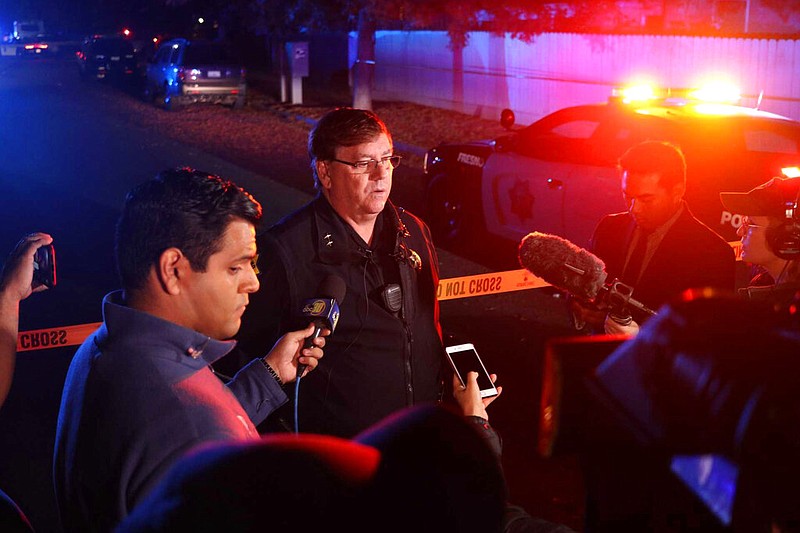Fresno Police Lt. Bill Dooley speaks to reporters at the scene of a shooting at a backyard party Sunday, Nov. 17, 2019, in southeast Fresno, Calif. Multiple people were shot and at least four of them were killed Sunday at a party in Fresno when suspects sneaked into the backyard and fired into the crowd, police said. (Larry Valenzuela/The Fresno Bee via AP)