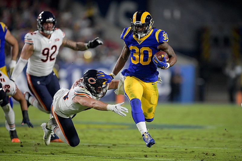 Los Angeles Rams running back Todd Gurley runs past Chicago Bears inside linebacker Nick Kwiatkoski during the first half of an NFL football game Sunday, Nov. 17, 2019, in Los Angeles. (AP Photo/Kyusung Gong)