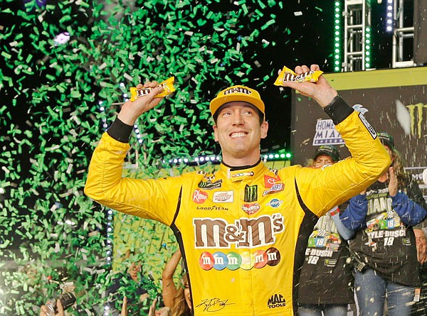 Kyle Busch celebrates in victory lane after winning the 2019 NASCAR Cup Series season championship Sunday at Homestead-Miami Speedway in Homestead, Fla.