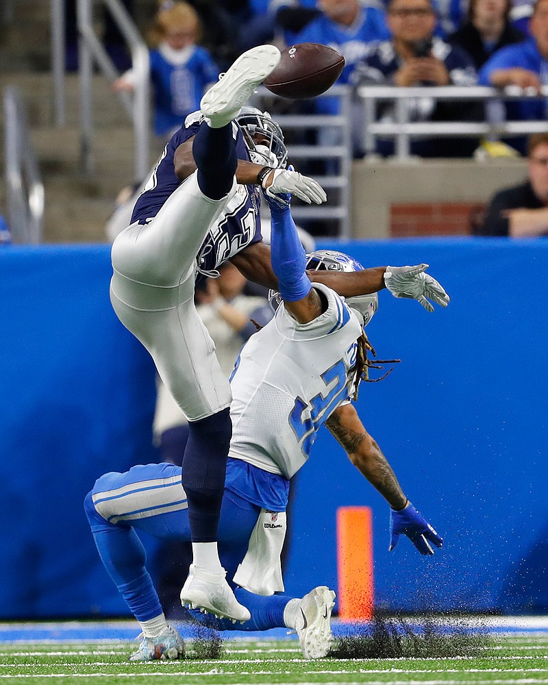 Detroit Lions defensive back Mike Ford (38) interferes with Dallas Cowboys wide receiver Michael Gallup (13) during the first half Sunday in Detroit.