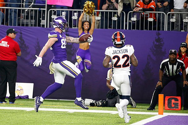 Vikings tight end Kyle Rudolph catches a 32-yard touchdown pass in front of Broncos strong safety Kareem Jackson during the second half of Sunday's game in Minneapolis.