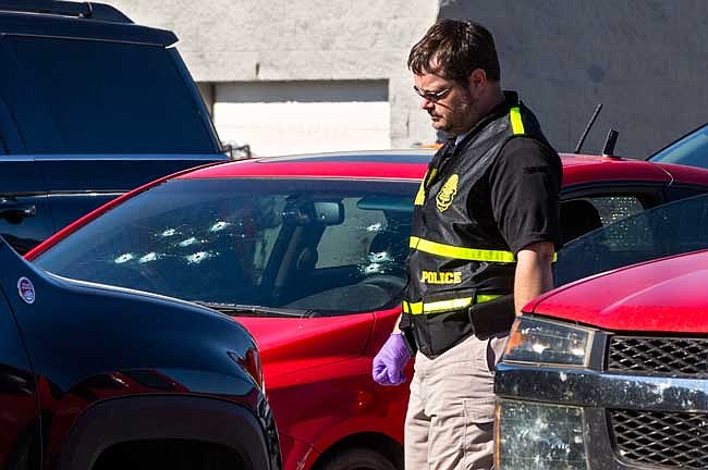 A member of the Oklahoma State Bureau of Investigation works the scene of a fatal shooting Monday in the parking lot of a Walmart in Duncan, Oklahoma