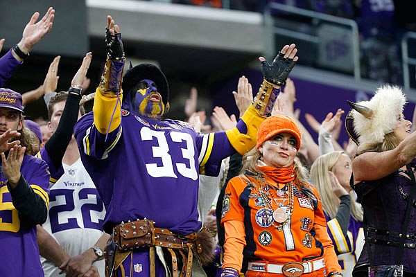 Fans react during the second half of Sunday's game between the Vikings and the Broncos in Minneapolis.