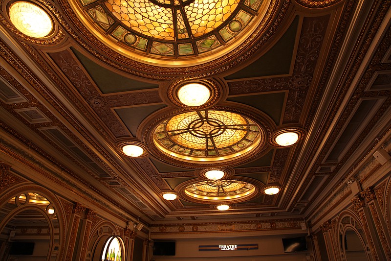 This Oct. 29, 2019 photo shows the triple-domed stained glass and bronze ceiling in the green marble lobby of the Hudson Theatre on West 44th Street in New York. A newly launched tour of the Hudson Theatre offers a rare chance to wander around the interior of Broadway’s oldest theater and hear some of the fascinating stories that have happened in its 116 years. (AP Photo/Mark Kennedy)
