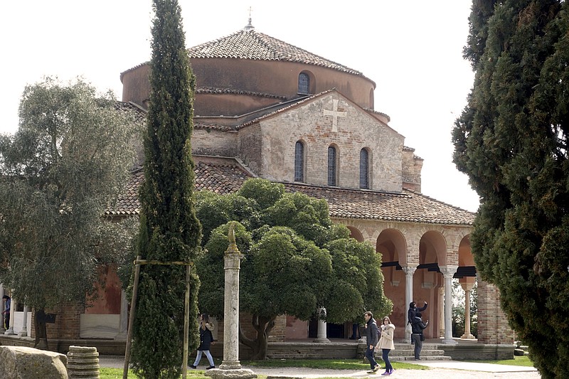 In this photo taken on Wednesday, March, 28, 2018, the Santa Maria Fosca Church, adjacent to the Santa Maria Assunta Basilica, one of the most ancient churches in Venice, located on the lagoon island of Torcello, Italy. The churches were flooded three times during last week's record-breaking flooding. Damage has not been calculated, but because of the island's position, water did not recede as quickly as it did from the historic center of Venice. (AP Photo/Martino Masotto)