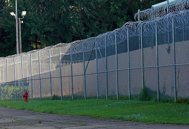 In this June 12, 2015, file photo, fencing surrounds the Hinds County Detention Center in Raymond, Miss. Mississippi's habitual offender laws are causing "extreme" prison sentences that are disproportionately affecting African American men and are costing the state millions of dollars for decades of incarceration, according to a new report released Tuesday, Nov. 19, 2019, by a nonprofit advocacy group founded by technology and business executives. Mississippi has the third-highest imprisonment rate among U.S. states, according to the U.S. Justice Department. (AP Photo/Rogelio V. Solis, File)