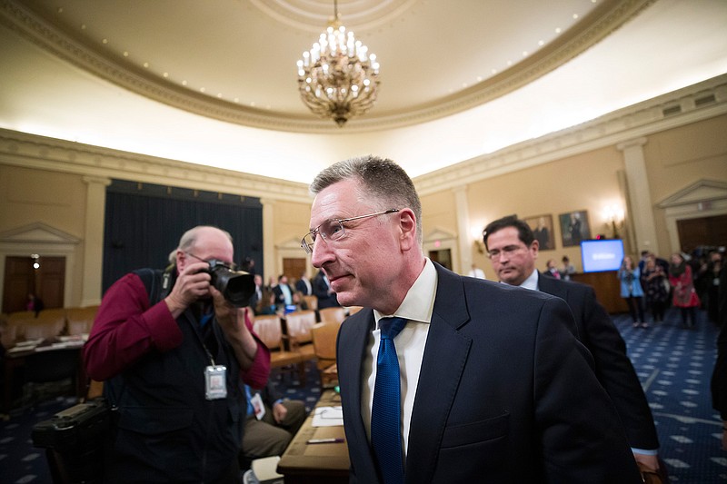 Ambassador Kurt Volker, center, former special envoy to Ukraine, departs after testifying before the House Intelligence Committee on Capitol Hill in Washington, Tuesday, Nov. 19, 2019, during a public impeachment hearing of President Donald Trump's efforts to tie U.S. aid for Ukraine to investigations of his political opponents. (AP Photo/Alex Brandon)
