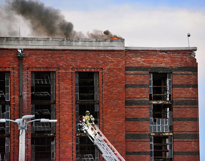 A firefighter climbs at ladder Wednesday as Jefferson City Fire Department units respond to a fire that broke out at Housing Unit 2 at the Missouri State Penitentiary.