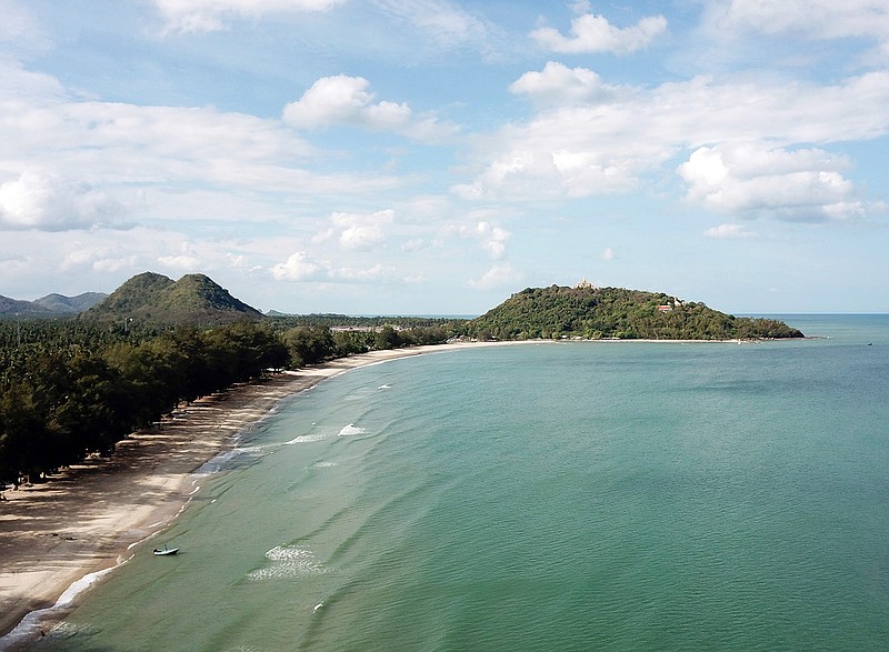 This June 15, 2019 photo shows Ban Krut beach in the Prachuap Khiri Khan province of Thailand. You won't find the party scene of Phuket or Pattaya in laid-back Ban Krut, but you will get one of the cleanest and quietest stretches of white sand within driving distance of the capital. (AP Photo/Nicole Evatt)