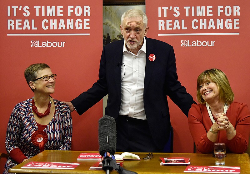 Britain's main opposition Labour Party leader Jeremy Corbyn, centre, with Dudley North candidate Melanie Dudley, right, and Dudley South candidate Lucy Caldicott at the Pensioner Club in Dudley, England, Thursday, Nov. 21, 2019, as the UK prepares for a General Election on Dec. 12. (AP Photo/Rui Vieira)