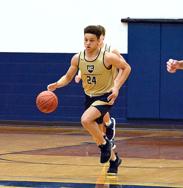 Marcus Anthony of Helias dribbles the ball up the court during a scrimmage against Blair Oaks in Thursday's Jamboree at Rackers Fieldhouse.