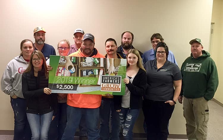 <p>Submitted</p><p>Local farmer Adam Kroll presents a check from the American Farmers Grow Communities program to the Callaway Youth Expo board. The funds will purchase upgrades for the Callaway Youth Expo livestock barns at the Auxvasse Lion’s Park.</p>