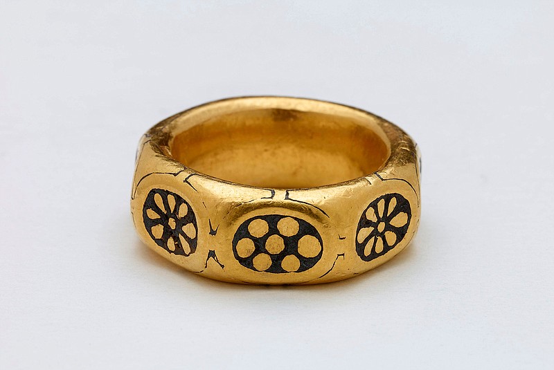 This undated handout photo provided by the British Museum shows a gold ring from the ninth century which was part of a £3 million Viking hoard, metal detectorists George Powell and Layton Davies have been convicted of stealing. Two amateur British treasure-hunters have on Friday, Nov. 22, 2019 been imprisoned for stealing a hoard of 1,100-year-old Anglo-Saxon coins and jewelry valued at millions of pounds. Experts say the hoard, much of which is still missing, could shed new light on a period when Saxons were battling Vikings for control of England. (British Museum via AP)