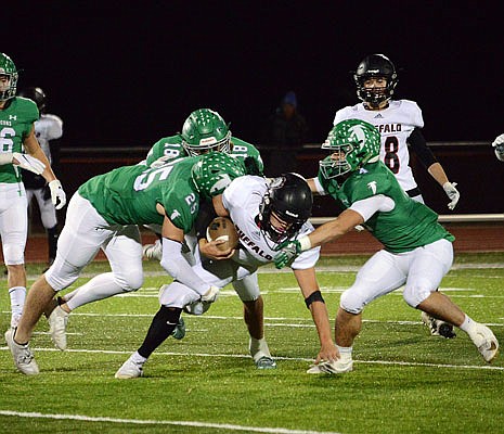 Blair Oaks teammates (from left) Levi Haney, Ian Nolph and Jayden Purdy team up to tackle Jamen Smith of Buffalo during last Friday's district championship game at the Falcon Athletic Complex in Wardsville.
