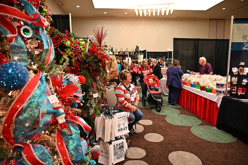 Holiday shoppers browse the booths and products Friday at the Junior League's annual Mistletoe Market at the Arkansas Convention Center in Texarkana. The event continues from noon to 4 p.m. today and Sunday.