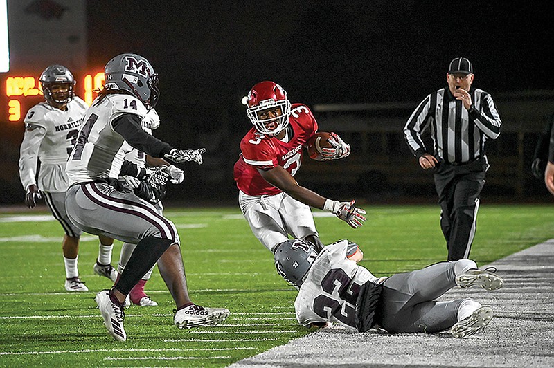 Arkansas High running back Torie Blair dodges Morrilton defenders before being forced out of bounds in a Class 5A quarterfinal game Friday at Razorback Stadium. 