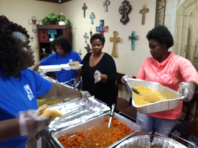 Volunteers served turkey and all the trimmings at the neighborhood Thanksgiving feast at the Sandflat Glendale Shannon Neighborhood Center.