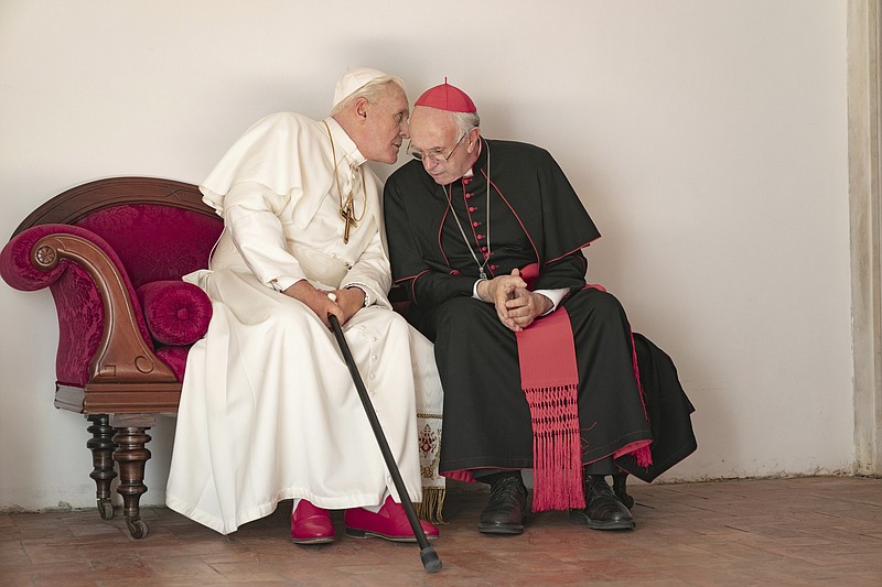 This image released by Netflix shows Jonathan Pryce as Cardinal Bergoglio, right, and Anthony Hopkins as Pope Benedict in a scene from "The Two Popes."   AARP has released nominations for its annual Movies for Grownups awards, which is designed to reward films that resonate with older viewers and fight industry ageism.  AARP The Magazine on Tuesday, Nov. 26, 2019 nominated “A Beautiful Day in the Neighborhood,” “Bombshell,” “Little Women,” “Marriage Story,” “Once Upon a Time in Hollywood,” “The Farewell,” “The Irishman” and “The Two Popes” for the best picture/best movie category.  (Peter Mountain/Netflix via AP)