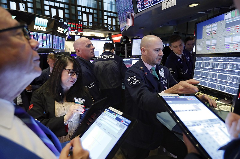 FILE - In this Nov. 20, 2019, file photo specialist Mario Picone, right, works with traders at his post on the floor of the New York Stock Exchange. The U.S. stock market opens at 9:30 a.m. EST on Tuesday, Nov 26. (AP Photo/Richard Drew, File)