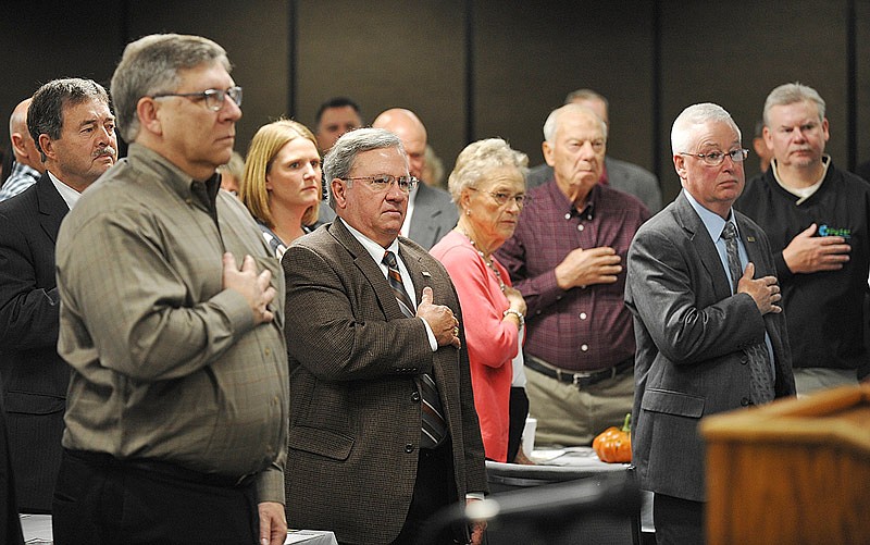 Prayer breakfast attendees stand for the Pledge of Allegiance to kick off the annual Jefferson City Area Chamber of Commerce Prayer Breakfast Wednesday, Nov. 27, 2019, at Missouri Farm Bureau headquarters. 