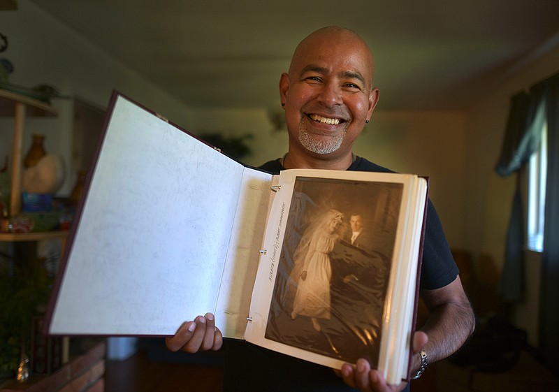 San Antonian Mike Rodriguez purchased this photo album for $8 in a flea market. The album has family photos dating back to the 1800s, and Rodriguez was able to track down a relative of the people pictured in the album in Minnesota and plans to return it. (Billy Calzada/San Antonio Express-News via AP)