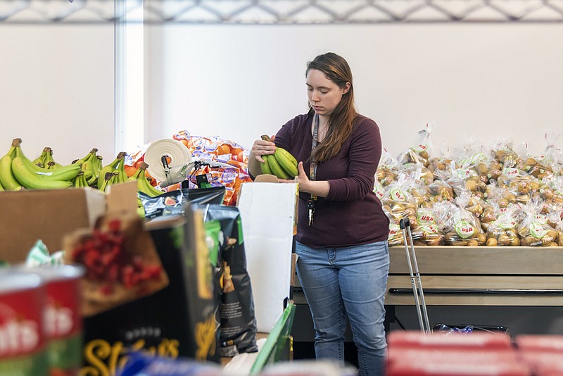 In this Tuesday, Nov. 5, 2019 photo, sophomore Tamera Teets shops during the grand opening of the new Gator Mart in partnership with the Houston Food Bank at Brazosport College in Clute, Texas.  (Katie Frezza/The Brazosport Facts via AP)