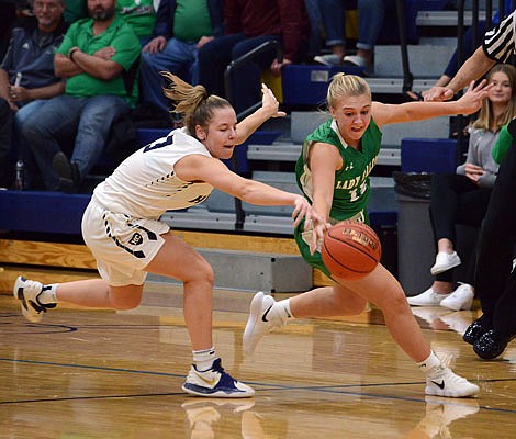 Bailey Rissmiller of Blair Oaks and Lainy Lamb of Helias battle for a loose ball during Tuesday night's game at Rackers Fieldhouse.