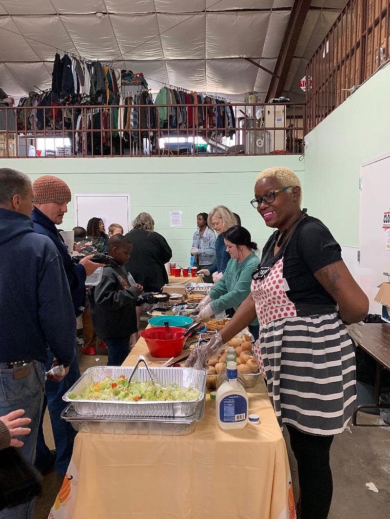 Volunteers serve a Thanksgiving meal Thursday at Randy Sams Outreach Shelter