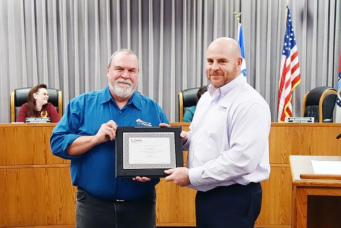 Rick Shiverdecker, left, deputy mayor in Lowe Cannell's absence Tuesday night, poses with Patrick Bonnot, of the Missouri Intergovernmental Risk Management Association. MIRMA helped the city win more than $10,000 in grants toward useful equipment.