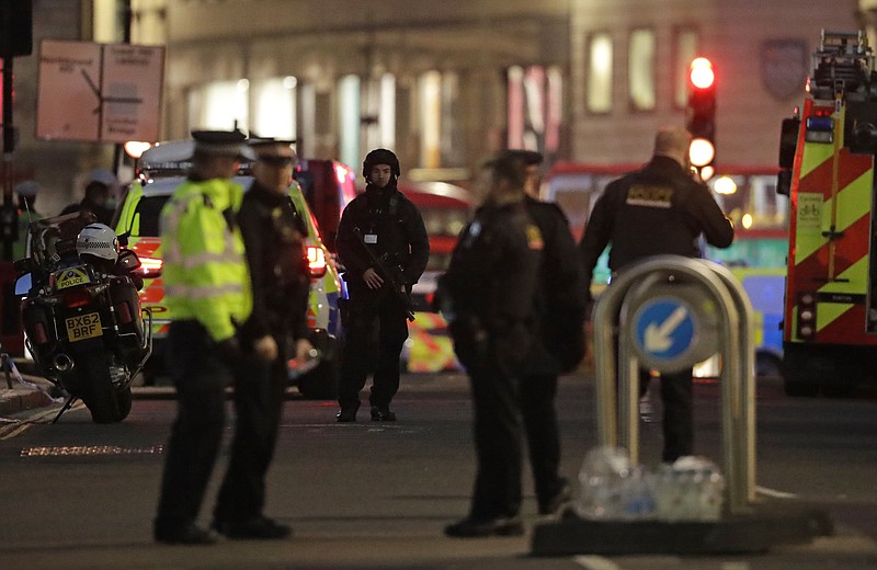 Armed police officers on the north side of London Bridge in London, Friday, Nov. 29, 2019. British police shot a man on London Bridge in the heart of Britain's capital on Friday after a stabbing that left several people wounded. The Metropolitan Police force said the circumstances were still unclear, but "as a precaution, we are currently responding to this incident as though it is terror-related." (AP Photo/Matt Dunham)