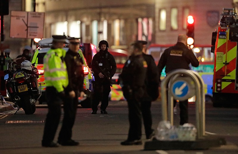 Armed police officers on the north side of London Bridge in London, Friday, Nov. 29, 2019. British police shot a man on London Bridge in the heart of Britain's capital on Friday after a stabbing that left several people wounded. The Metropolitan Police force said the circumstances were still unclear, but "as a precaution, we are currently responding to this incident as though it is terror-related." (AP Photo/Matt Dunham)
