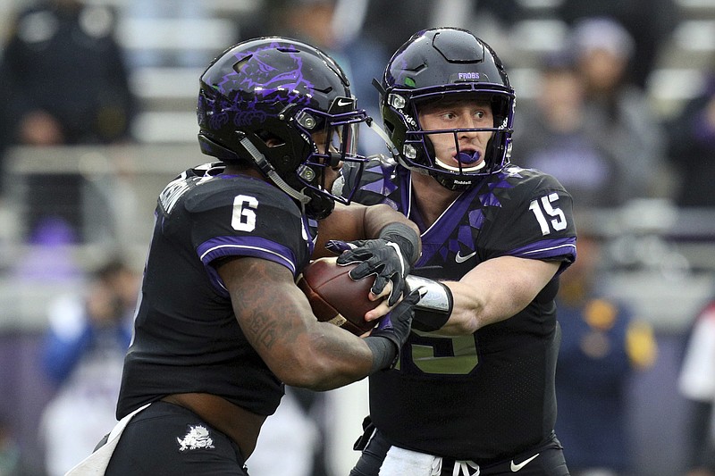 TCU running back Darius Anderson (6) takes the hand off from quarterback Max Duggan (15) in the first quarter of an NCAA college football game Friday, Nov. 29, 2019, in Fort Worth, Texas. (AP Photo/Richard W. Rodriguez)