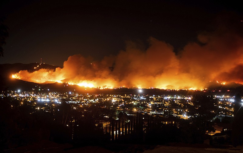 FILE - In this Oct. 31, 2019, file photo, smoke from the Maria Fire billows above Santa Paula, Calif. The nation's largest utility says its distribution lines have sparked no damaging wildfires since it began repeatedly shutting off power to hundreds of thousands of Northern California customers this fall. But Pacific Gas & Electric is not ruling out that failed transmission equipment may have started a fire north of San Francisco that damaged or destroyed more than 400 structures. (AP Photo/Noah Berger, File)