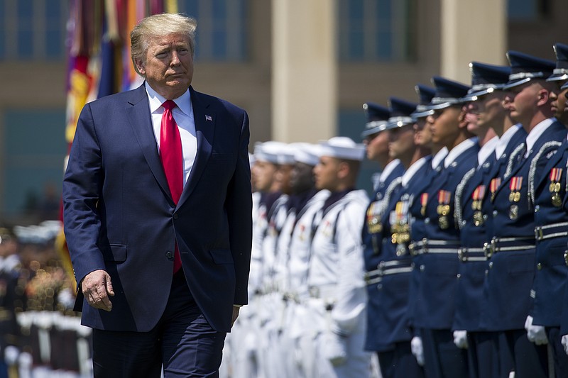 FILE - In this July 25, 2019, file photo, President Donald Trump reviews the troops during a full honors welcoming ceremony for Secretary of Defense Mark Esper at the Pentagon in Washington. If there was one day that crystallized all the forces that led to the impeachment investigation of President Donald Trump, it was July 25. That was the day of his phone call with Ukraine’s new leader, pressing him for a political favor.  (AP Photo/Alex Brandon, File)