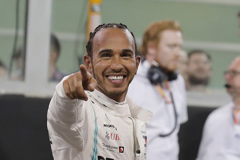 Lewis Hamilton celebrates Saturday after winning the pole at the Yas Marina racetrack in Abu Dhabi, United Arab Emirates.