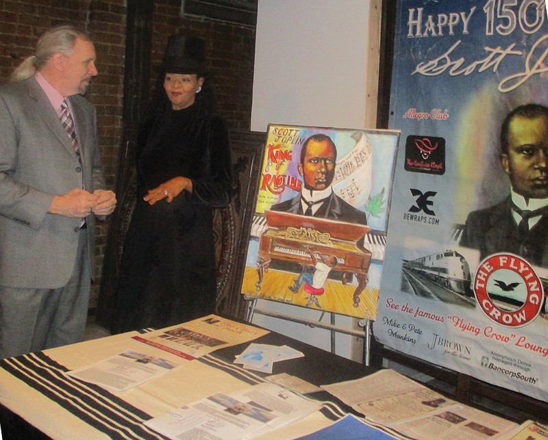 Carol Miles, a board member with the Texarkana Regional Music Heritage Center, talks to a patron Saturday during the 151st Birthday Celebration of Scott Joplin at the 1894 Gallery, 105 Olive St. 