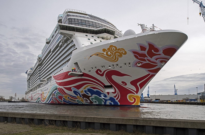 FILE - In this March 4, 2017, file photo, Norwegian's cruise liner "Joy" floats out of the Meyer shipyard's building dock in Papenburg, northern Germany. Authorities say over a dozen people aboard the cruise ship reported flu-like illnesses as they reached a Southern California port. The Los Angeles Fire Department says authorities were called early Sunday, Dec. 1, 2019, to evaluate patients after they fell ill onboard. Authorities say the patients were evaluated and declined to be taken to the hospital. (Ingo Wagner/dpa via AP, File)