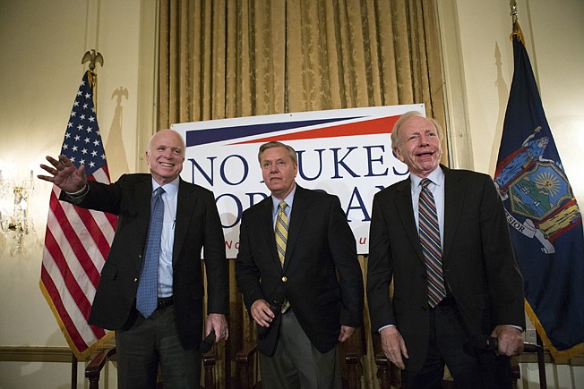 Sen. John McCain, R-Ariz., left, Sen. Lindsey Graham, R-S.C., center and former Sen. Joe Lieberman, I-Conn., right, arrive on stage July 20, 2015, at a town hall meeting at the 3 West Club to launch Graham's "No Nukes for Iran" tour in New York.
