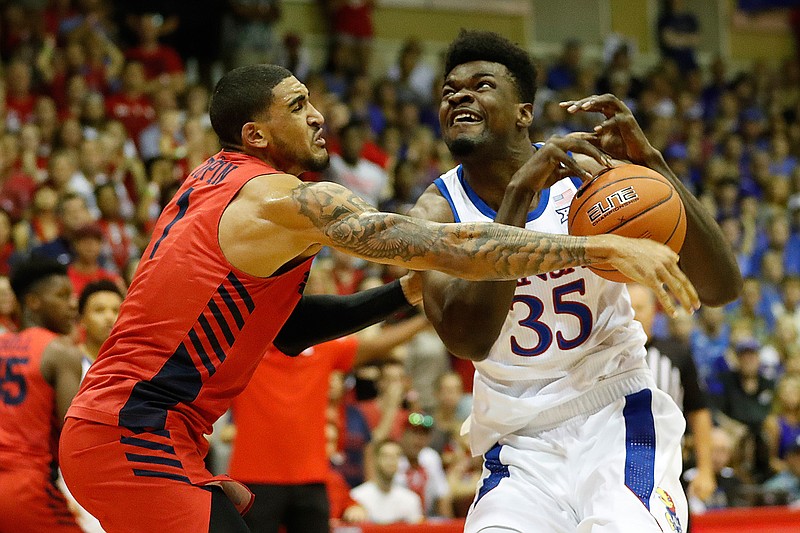 Dayton forward Obi Toppin (1) knocks the ball away from Kansas center Udoka Azubuike (35) on Wednesday during the first half of an NCAA basketball game in Lahaina, Hawaii. 