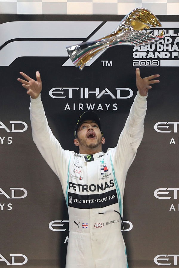 Mercedes driver Lewis Hamilton celebrates on the podium Sunday after winning the Emirates Formula One Grand Prix at the Yas Marina racetrack in Abu Dhabi, United Arab Emirates.
